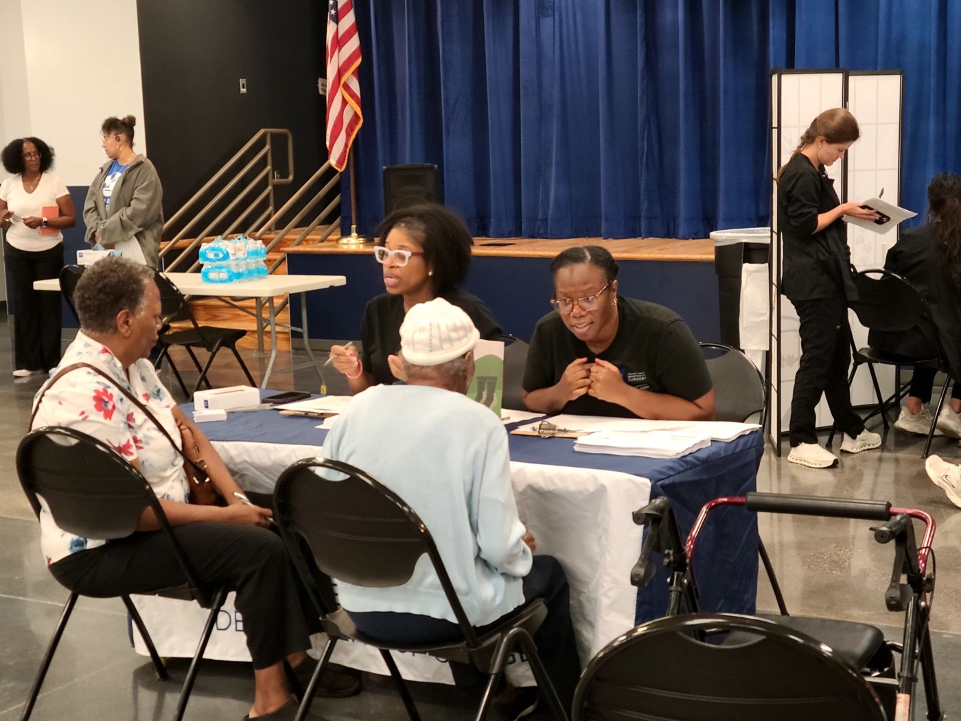 Neighbors talking with SALSAL volunteers at a table during the Houston screening
