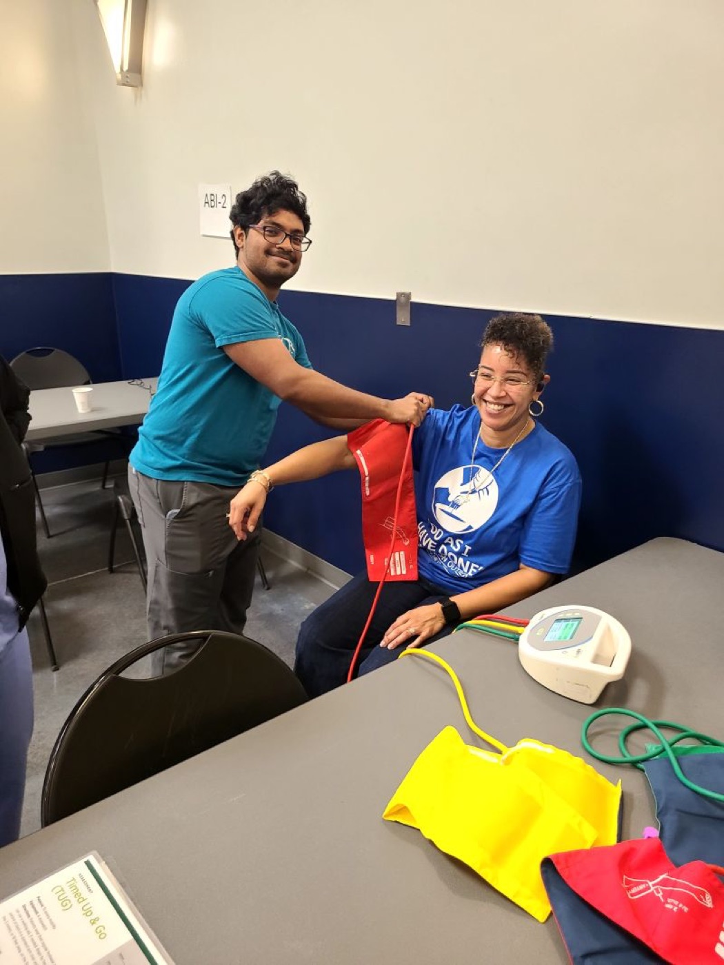A volunteer helping a guest with take-home resources at the Houston screening